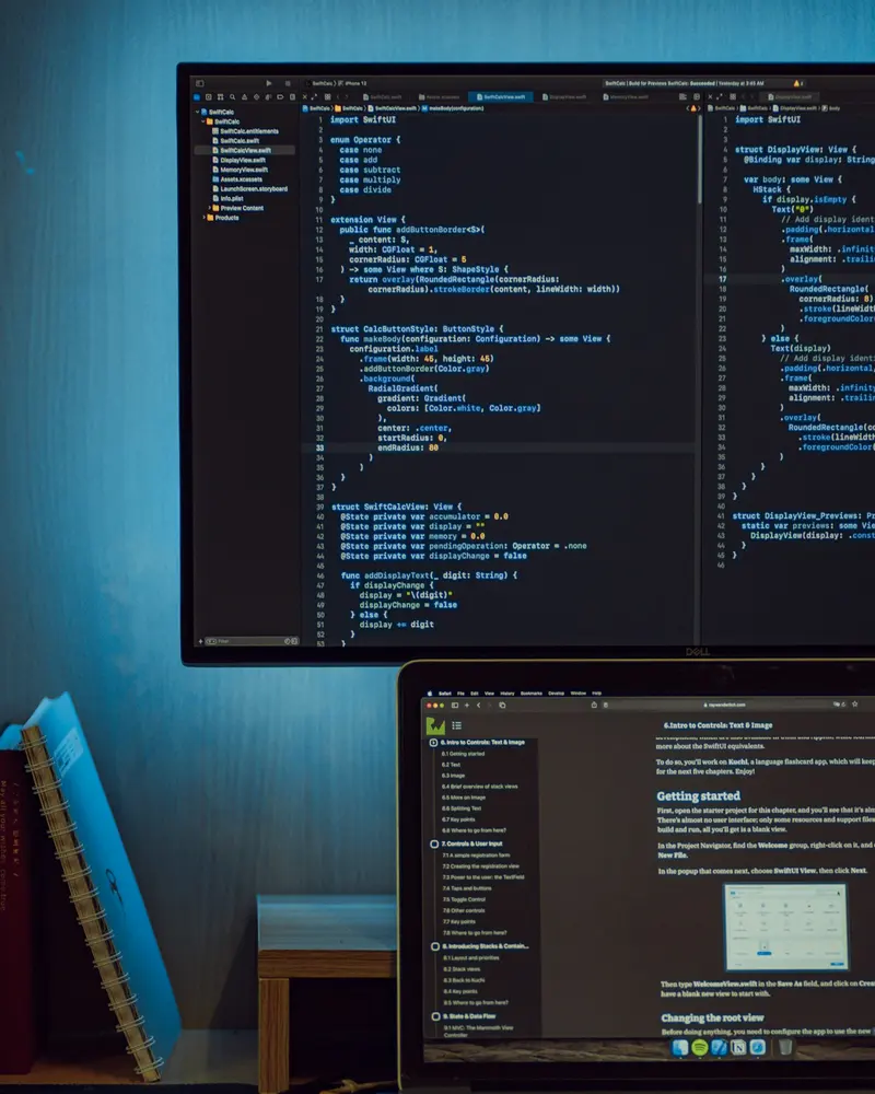 A developer workspace with screens showing code