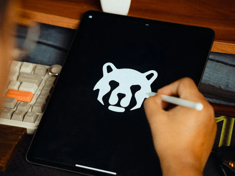 A designer drawing a logo on a tablet